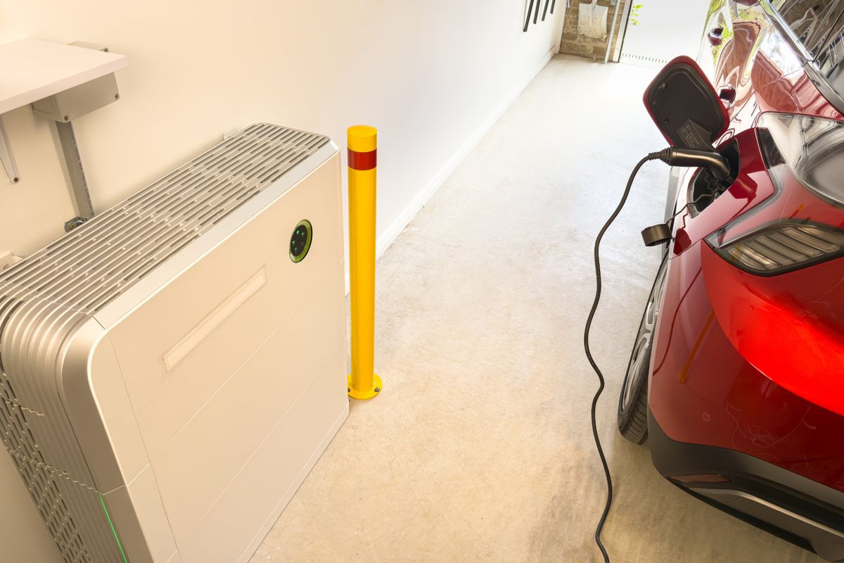 Electric car plugged in and charging in a home garage